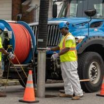A picture of a BWSC crew cleaning a sewer line with a vactor truck